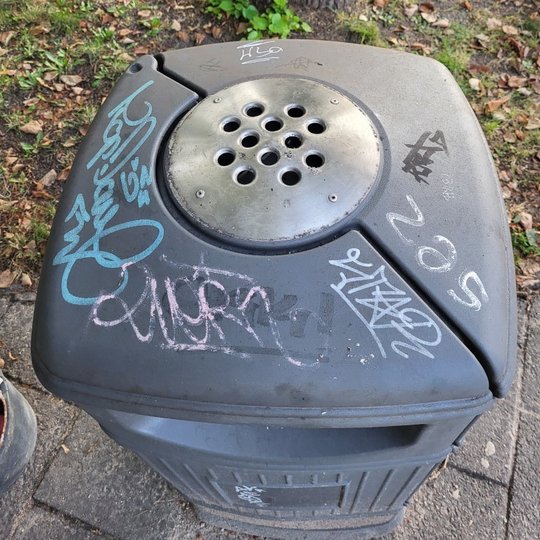 Graffiti išpaišyta šiukšlių dėžė. 