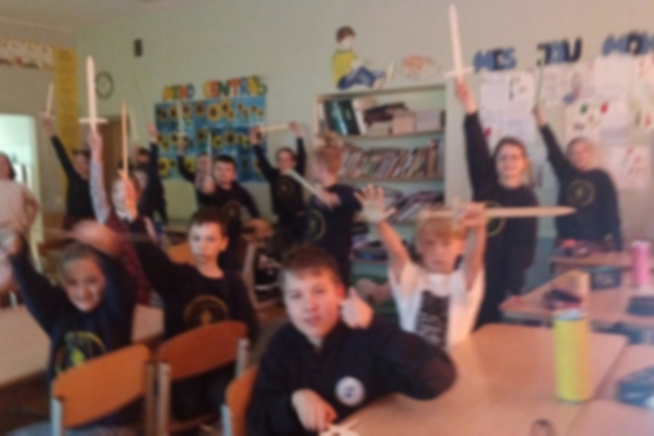 Trečiokai klasėje laiko medinius kalavijus.