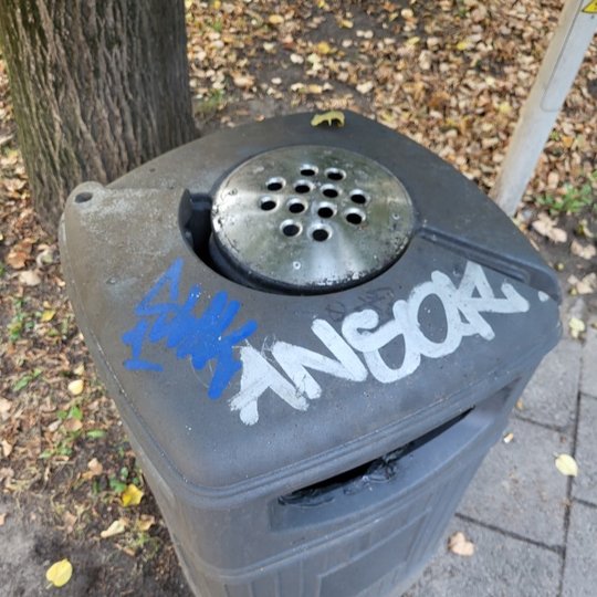 Graffiti išpaišyta šiukšlių dėžė. 