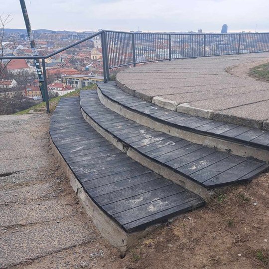 Trijų Kryžių kalno apžvalgos aikštelės laiptai apkalti medienos lentomis, nudažyti pilkšva spalva.