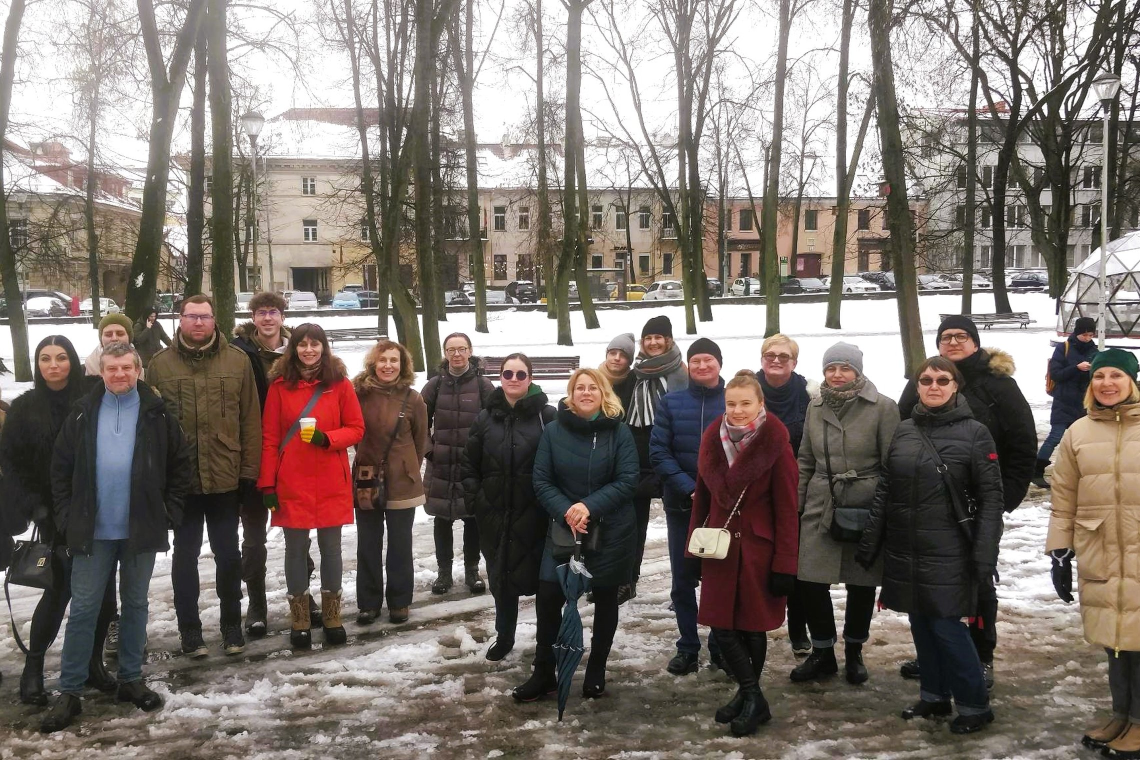 Kovo 11-osios ekskursijos dalyviai stovi Pilių parke, prie Vilniaus pilių kupolo.