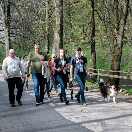 Grupė dalyvių keliauja Trispalvės alėja Bekešo pliažo link.