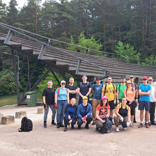 dvidešimt dviejų savanorių grupė Kalnų parko estradoje. Visi pasiruošę darbui.