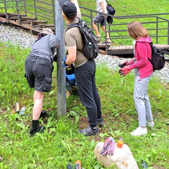 Keturi savanoriai valo gatvės šviestuvą kelyje į Kalnų parką.