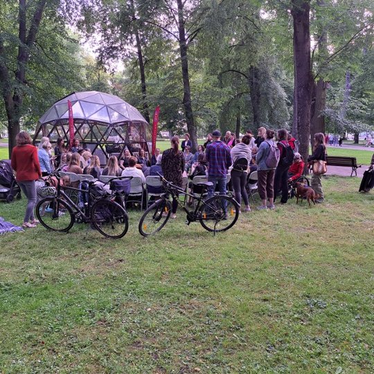 Moterys Sereikiškių parke, susėdę ratu, dainuoja sutartines.