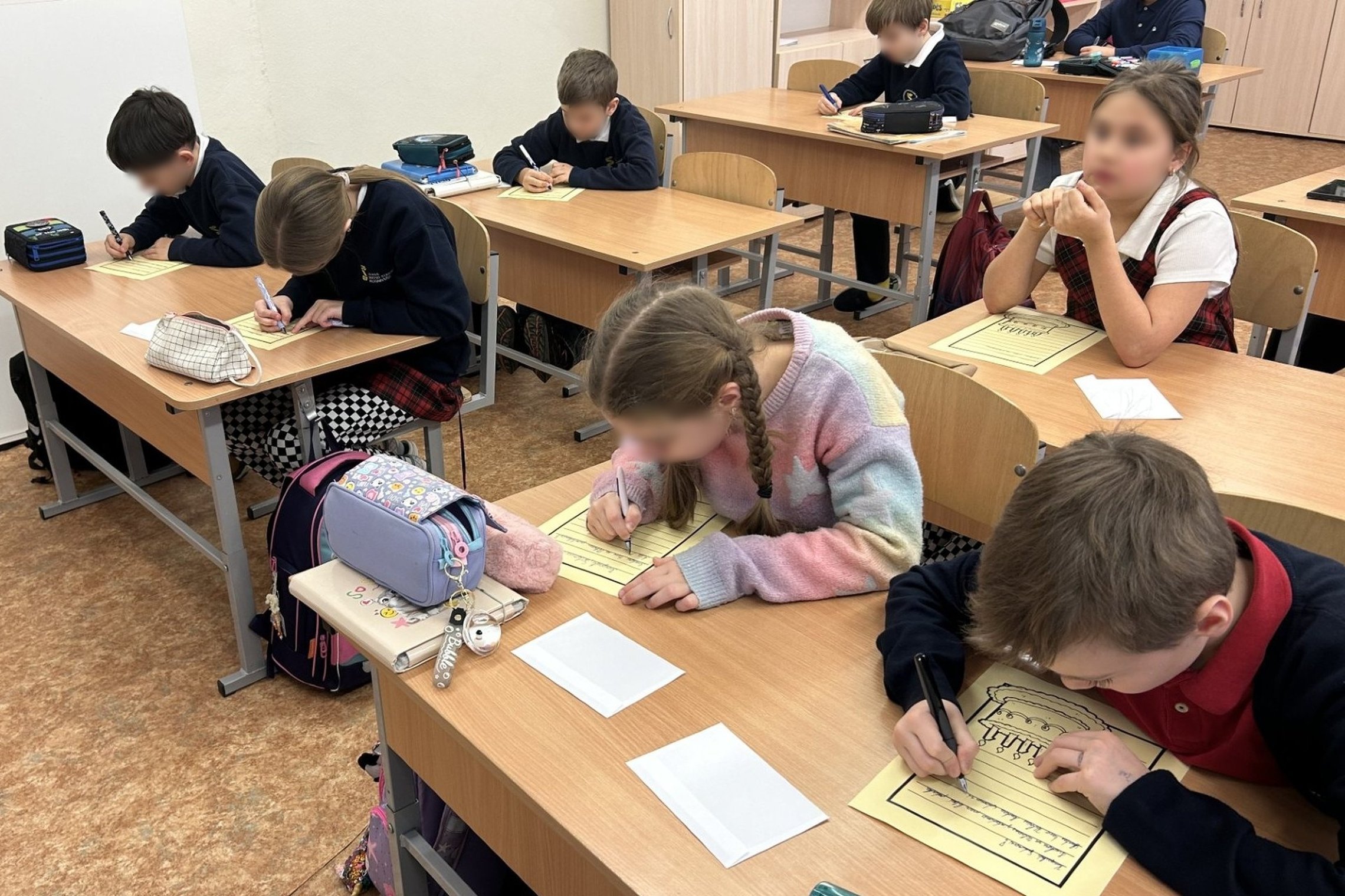 Nuotraukoje vaizduojama klasė, kurioje pradinukai susėdę suolose po du arba po vieną rašo laišką kunigaikščiui Gediminui. Laiškas blyškios spalvos, ant jo pavaizduotas didelis gimtadienio tortas. Vieni vaikai dar galvoja, ką rašys, o kiti susikaupę rašo.