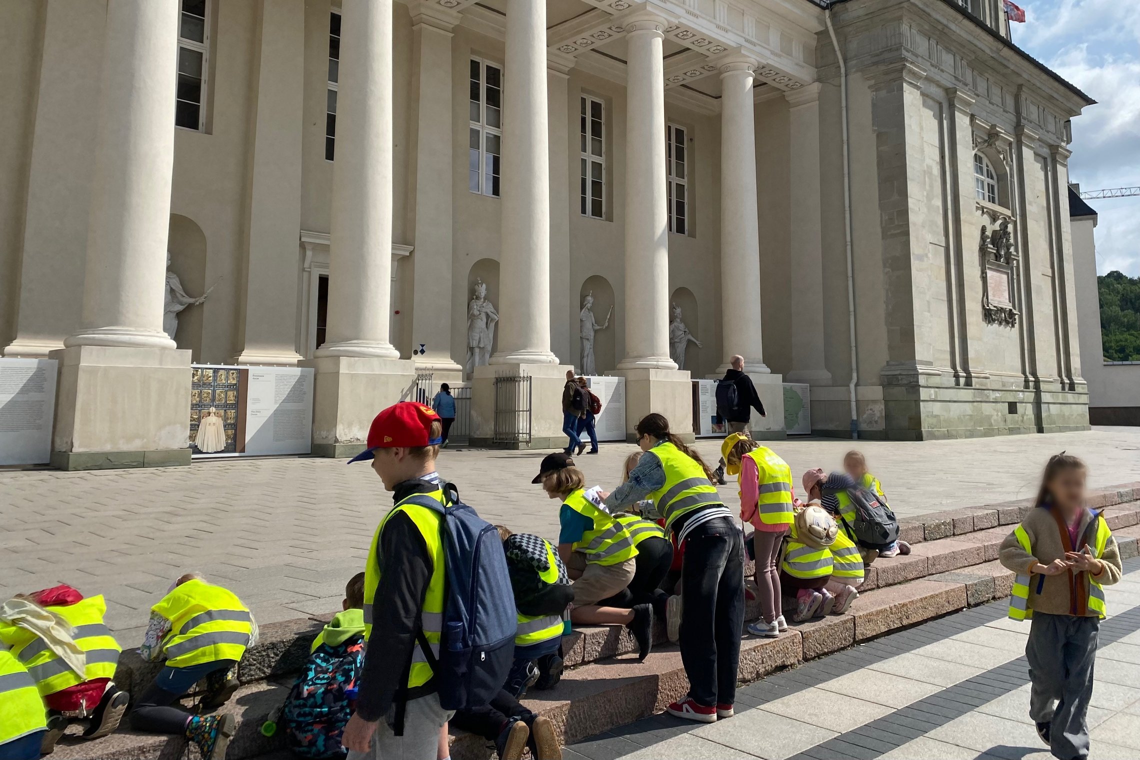 Vaikai Katedros aikštėje pildo užduočių knygutes