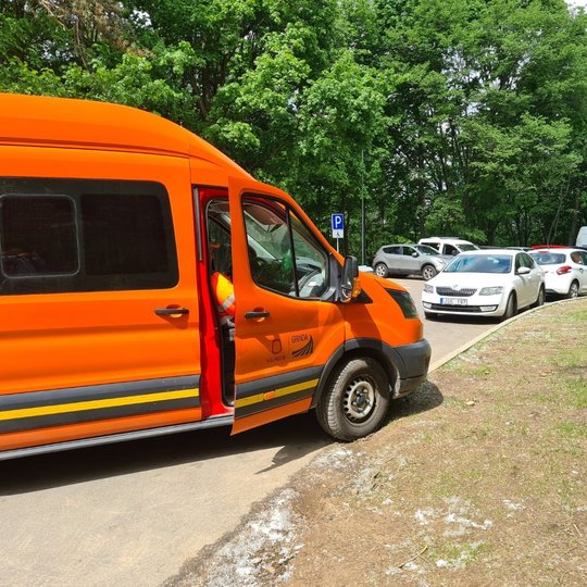 Netvarkingai sustatytos mašinos parkavimo aikštėje. Mašinų savininkams yra svetimos Kelių eismo taisyklės ir bandanti išdygti nauja gyvybė - žolė.