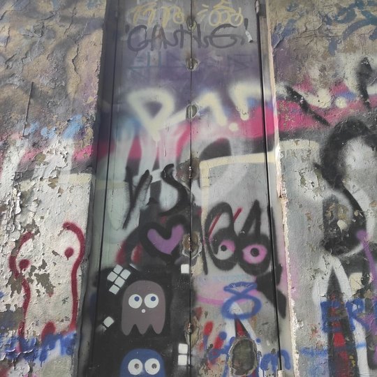 Bokštelio sienos išpaišytos graffiti piešiniais.