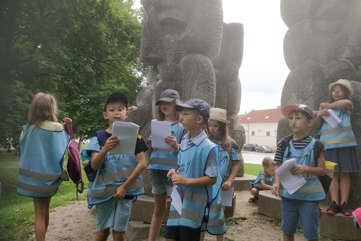  Parkas. Šalia Katedros, ant kalnelio V.Vildžiūno skulptūra „Lietuviška baladė“. Tai ratu stovintčios iš granito iškaltos tryjų barzdotų senolių galvos. Skulptūros didžiulė ir yra per visa nuotraukos aukštį. Šalia skulptūros pabiręs būrelis pradinukų – aš